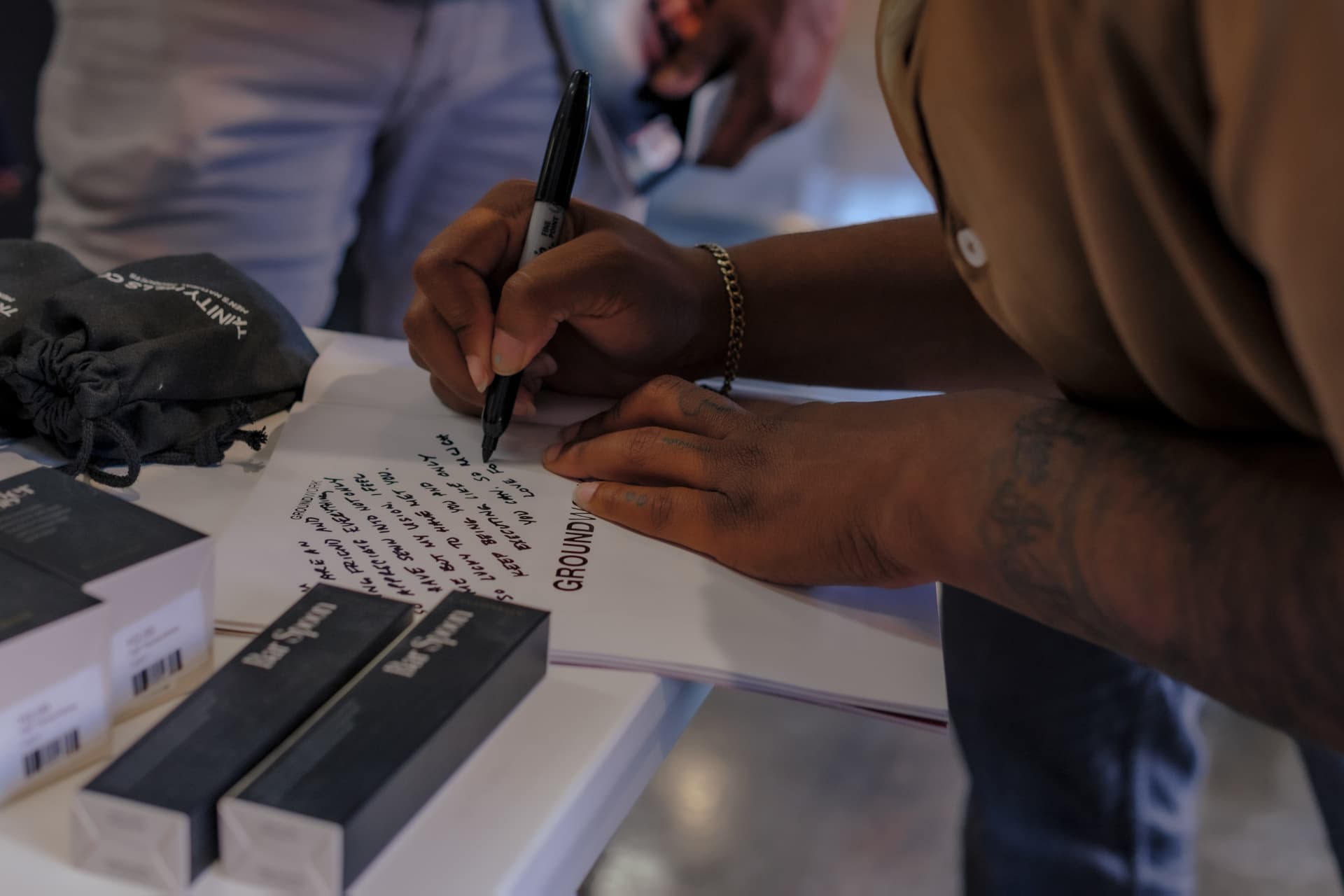 Jannae signing a copy of Groundwork Magazine